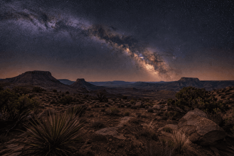Milky Way arching over desert landscape in New Mexico